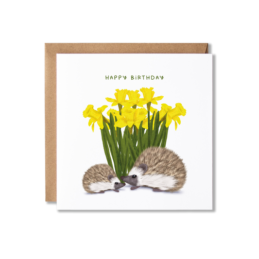 Birthday card with illustration of two hedgehogs, one larger one smaller, in front of a bunch of daffodils with the message Happy Birthday.