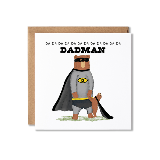 Birthday card with illustration of a bear stadning on back legs wearing a grey and black super hero costume, with a bear cub stood in front holding his hand wearing a black cape and another cub on his shoulder in a black eye mask, with the message Happy Birthday Daddy.