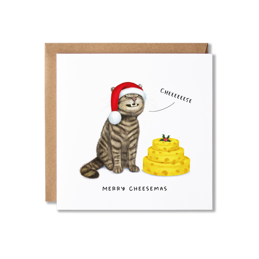 Christmas card with illustration of a tabby cat sat grinning, wearing a  Santa hat with a stack of cheeses in front of it with a sprig of holly on it so looks like a cake, saying Cheese and the message Merry Cheesemas.