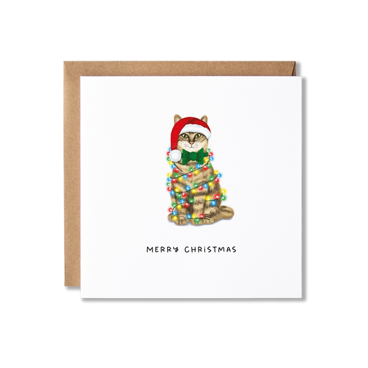 Christmas card with illustration of a brown tabby cat wrapped in Christmas lights with the message Merry Christmas underneath.
