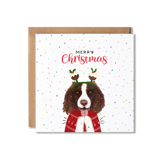 Christmas card with illustration of a Spaniel dog in a red Christmas jumper and wearing christmas pudding bobblers, clapping with the message Merry Christmas.