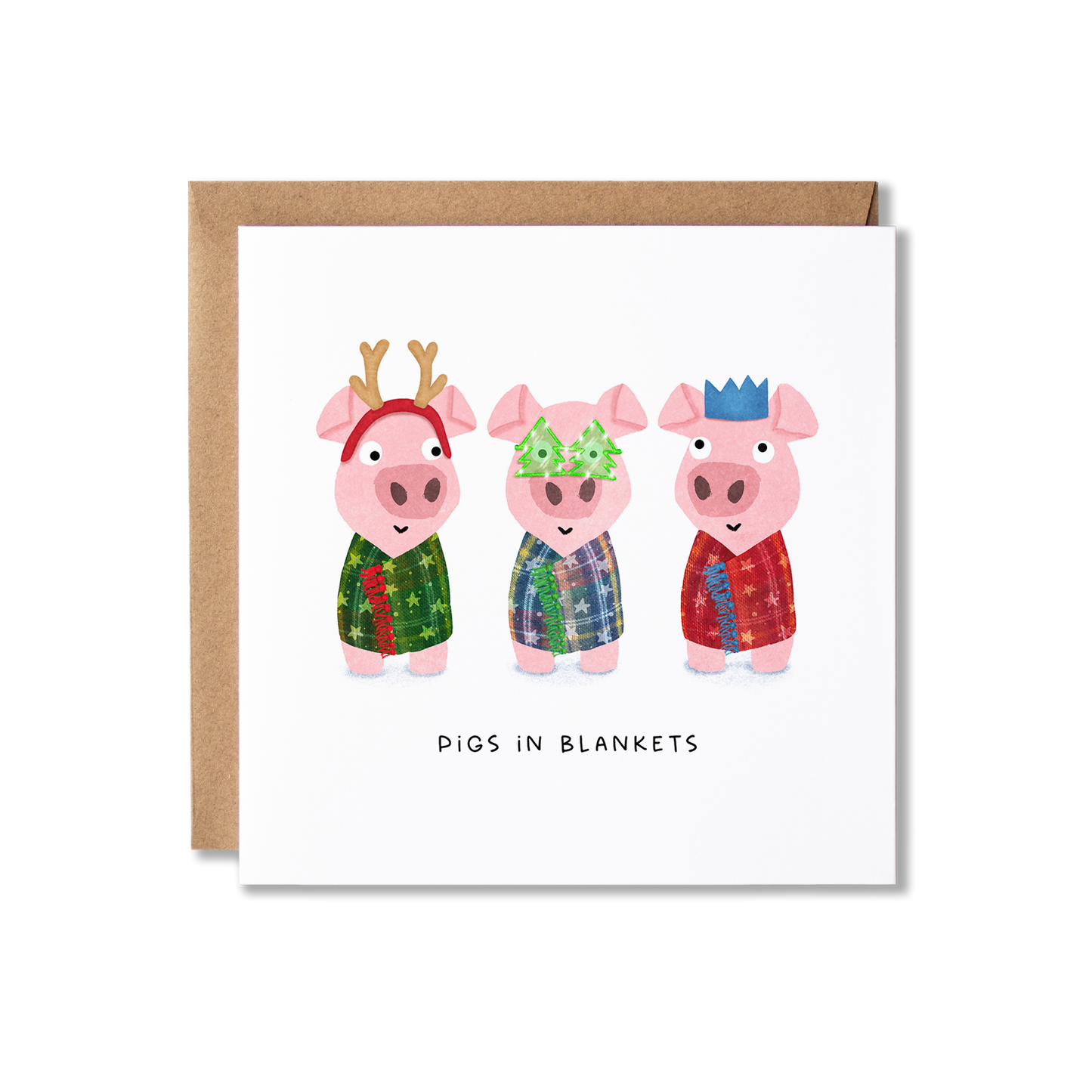 Christmas card with illustration of three little pigs wrapped in different colour blankets and different, as well as one wearing antlers, one wearing green Christmas shape glasses and the other wearing a red party hat crown, with the message Pigs in Blankets.
