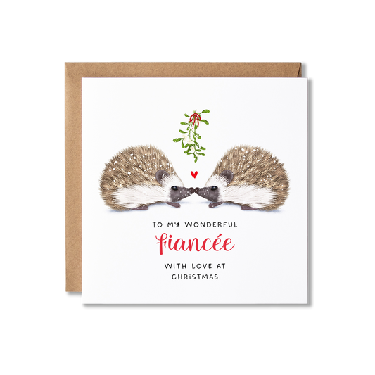 Christmas card with illistration of a couple of hedgehogs sitting underneath some springs of mistletoe tied in a red ribbon with a small red heart shape between them, with the message To My Wonderful Fiancee.