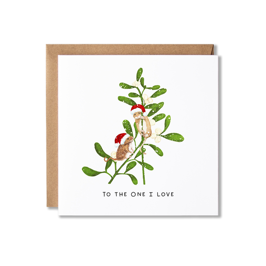 Christmas card with illustration of two mice wearing Santa hats stnading on some mistletoe in the snow with the message To the One I Love.