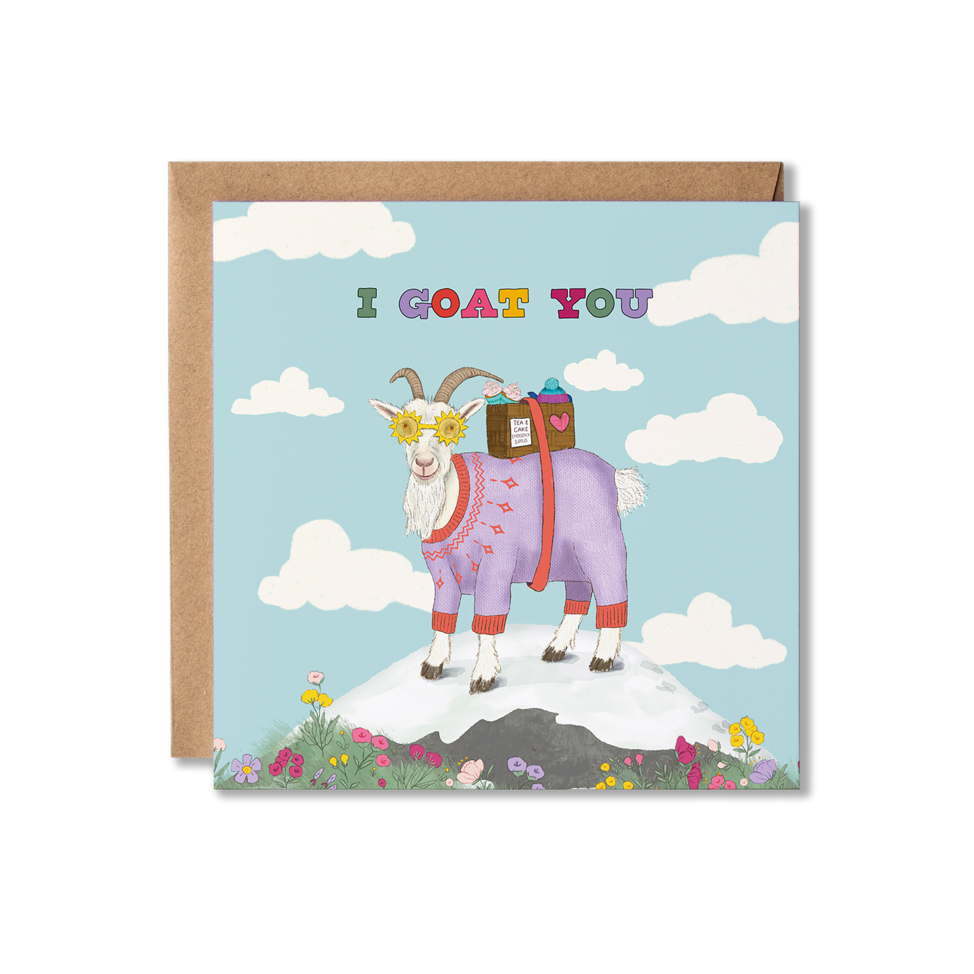 Illustration of a goat on top of a mountain in the middle of a blue sky with clouds around it, wearing a purple jumper and yellow sunshine glasses on, carrying a box of tea and cakes. The multi coloured words, I goat you, is written above. Thinking of You greeting card.