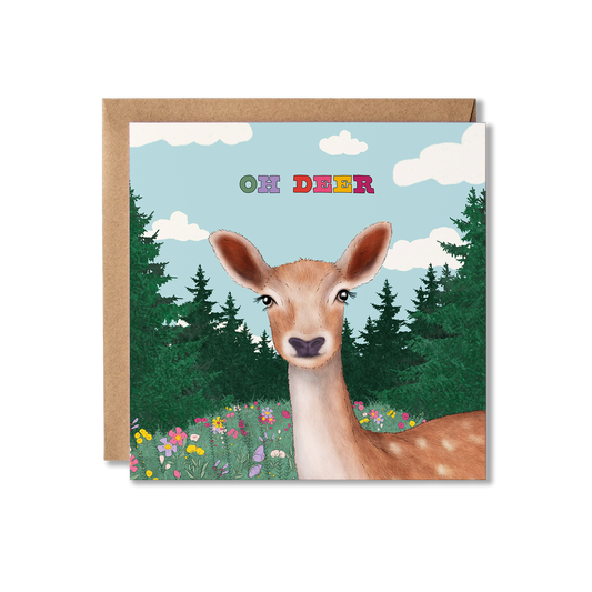 Illustration of a deer in a flower meadow with trees surrounding it. The blue sky has clouds in it with the words Oh  Deer in colourful letters. Thinking of You greeting card.