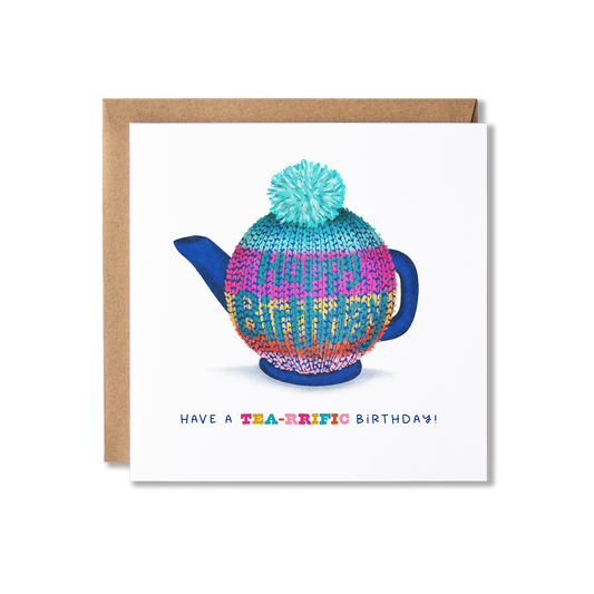 Birthday card with illustration of a blue teapot in a brightly coloured horizontal striped knitted tea cozy that has Happy Birthday on it with the message Have a Tea-rrific Birthday.