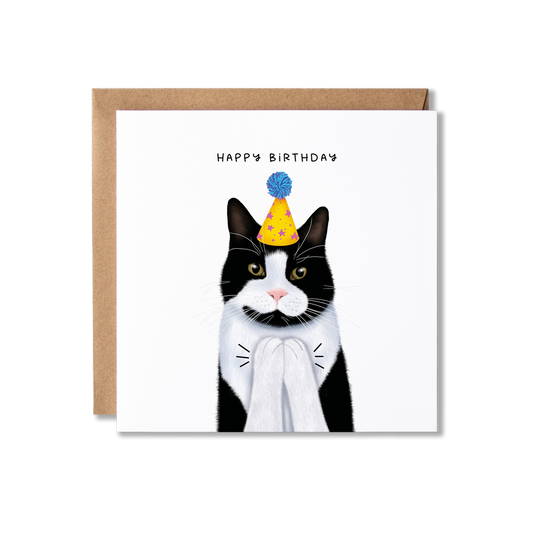 Birthday card with illustration of a black and white cat in a yellow party hat with a blue bobble on top, clapping with the message Happy Birthday.