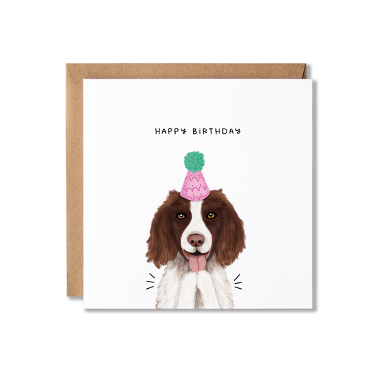 Birthday card with illustration of a Spaniel dog in a pink party hat with a green bobble on top, clapping with the message Happy Birthday.