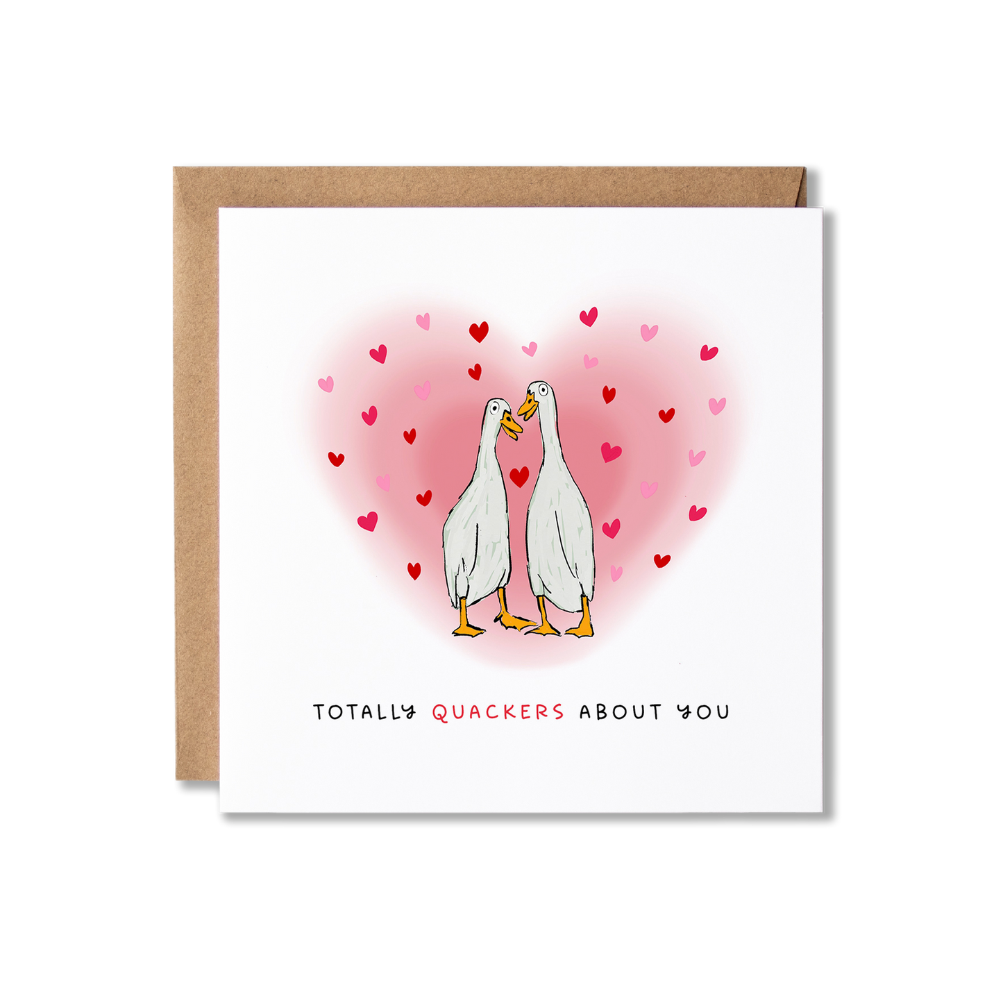Greeting card with illustration of two white ducks looking at each other surrounded by a hug pink heart with the message Totally Quackers About You.