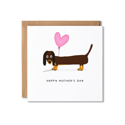 Mother's Day card with illustration of a Dachshund sausage dog holding a pink heart balloon with the message Happy Mother's Day underneath.