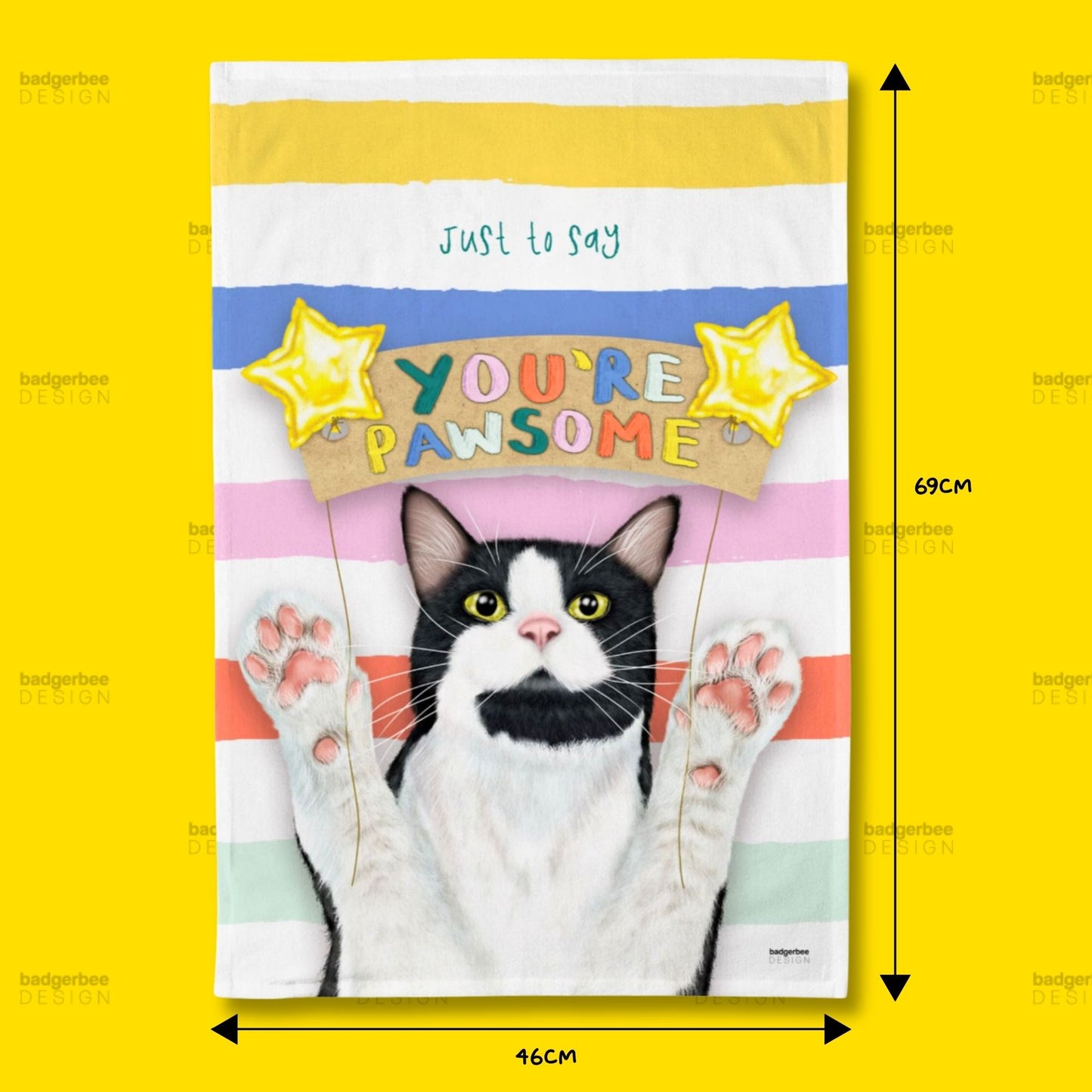 A rectangular printed Tea Towel against a bright yellow background, with dimension arrows and labels indicating 69 cm height and 46 cm width. The product has horizontal pastel stripes in yellow, white, blue, pink, and mint, a black-and-white cat illustration with raised paws, and the text 'just to say YOU'RE PWSOME' with yellow star graphics.