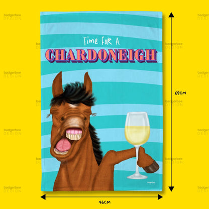 A rectangular printed tea towel with a illustration of a horse holding a glass of white wine against a turquoise striped background, with the text 'Time For A CHARDONEIGH' at the top. Black dimension arrows and labels indicate 46 cm width and 69 cm height, set on a bright yellow background.