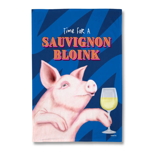 A rectangular printed tea towel featuring a pink pig holding a glass of white wine against a blue striped background, with the text 'Time For A Sauvignon Bloink' in stylized lettering.