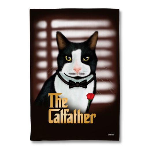 A rectangular printed tea towel featuring an illustrated black-and-white cat wearing a bow tie and holding a red rose, with the text 'The Catfather' in gold. The artwork is shown against a plain white background.