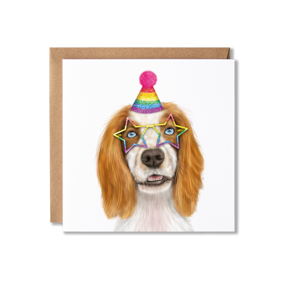 Tan and white spaniel dog in a sparkly rainbow party hat and star shaped glasses on a white background greeting card