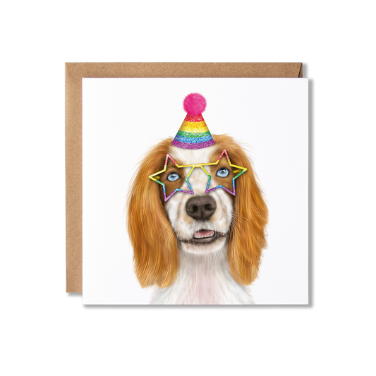 Tan and white spaniel dog in a sparkly rainbow party hat and star shaped glasses on a white background greeting card