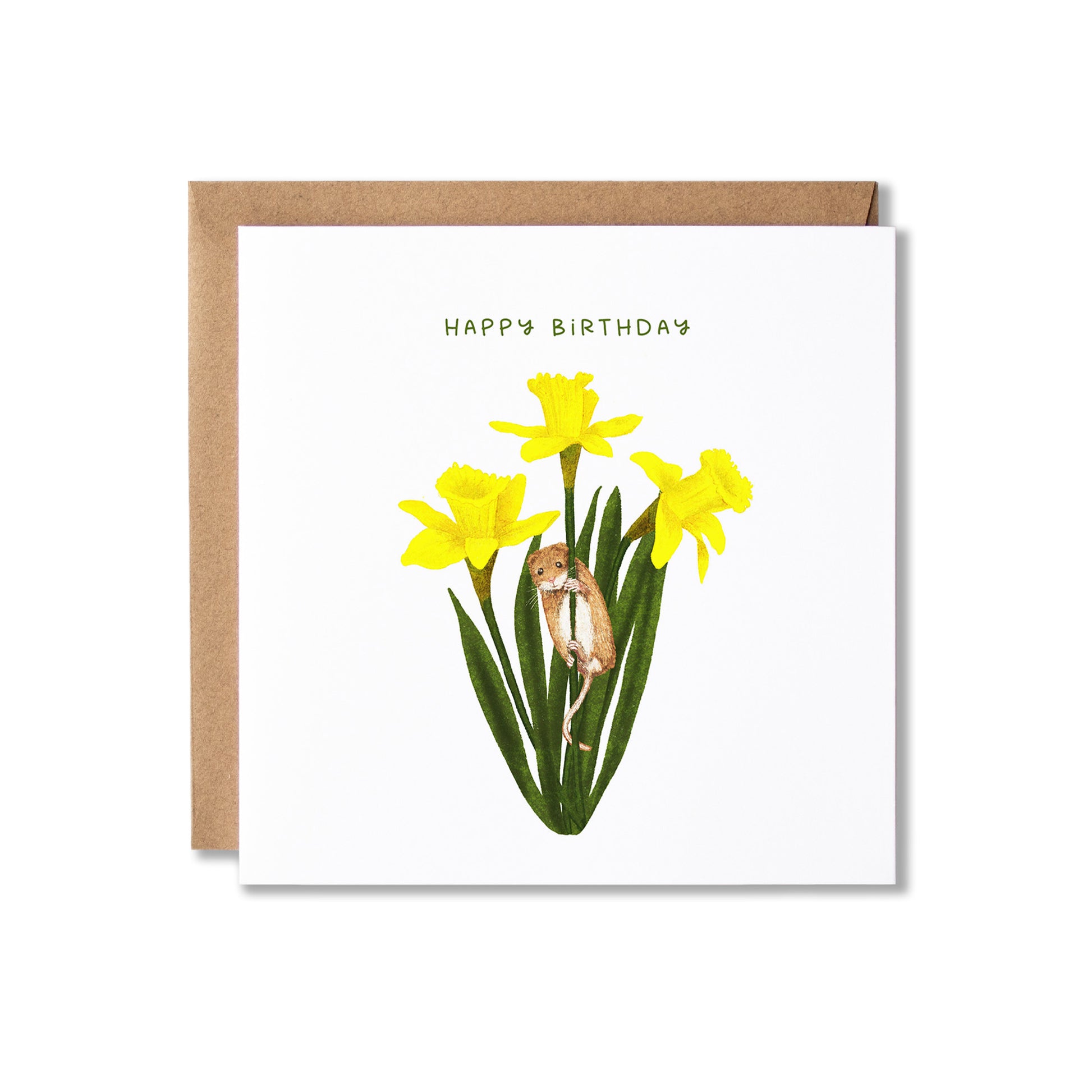 A square white birthday card with a brown kraft envelope behind it, featuring yellow daffodils, green leaves, and a small brown mouse illustration with the text 'HAPPY BIRTHDAY' at the top.