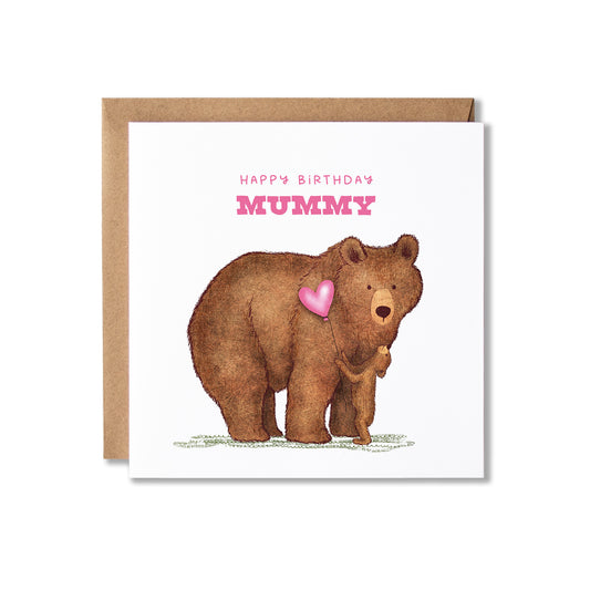 A square birthday card with a brown kraft envelope behind it. The card has an illustration of a brown bear with two bear cubs holding a pink heart balloon, with the text 'HAPPY BIRTHDAY MUMMY' in pink at the top.