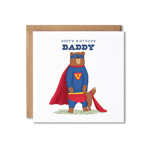 A square birthday card with a kraft envelope, featuring an illustration of a bear dressed as Super heron holding hands with a bear cub, and the text 'HAPPY BIRTHDAY DADDY' on a white card background.
