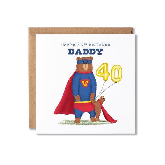 A square birthday card with a kraft envelope behind it, featuring an illustration of a bear dressed as Superman holding hands with a bear cub and yellow number 40 balloons. The card reads 'HAPPY 40TH BIRTHDAY DADDY'.