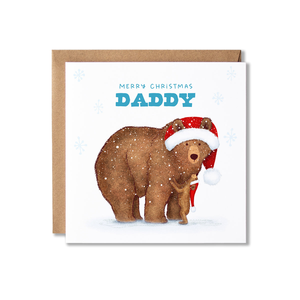 A square Christmas greeting card with a kraft envelope behind it. The card features an illustration of a brown bear wearing a red Santa hat on a white snowy background with a bear cub looking up to him, with the text 'MERRY CHRISTMAS DADDY' in blue.