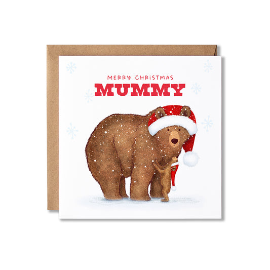 A square Christmas greeting card with a kraft envelope behind it. The card features an illustration of a brown bear wearing a red Santa hat on a white snowy background with a small bear cub looking up to her, with the text 'MERRY CHRISTMAS MUMMY' in red and light blue snowflake accents.