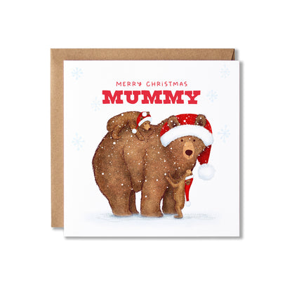 A square Christmas greeting card with a kraft envelope behind it. The card features an illustration of a brown bear and two smaller bears wearing Santa hats, with the text 'MERRY CHRISTMAS MUMMY' in red on a white background.