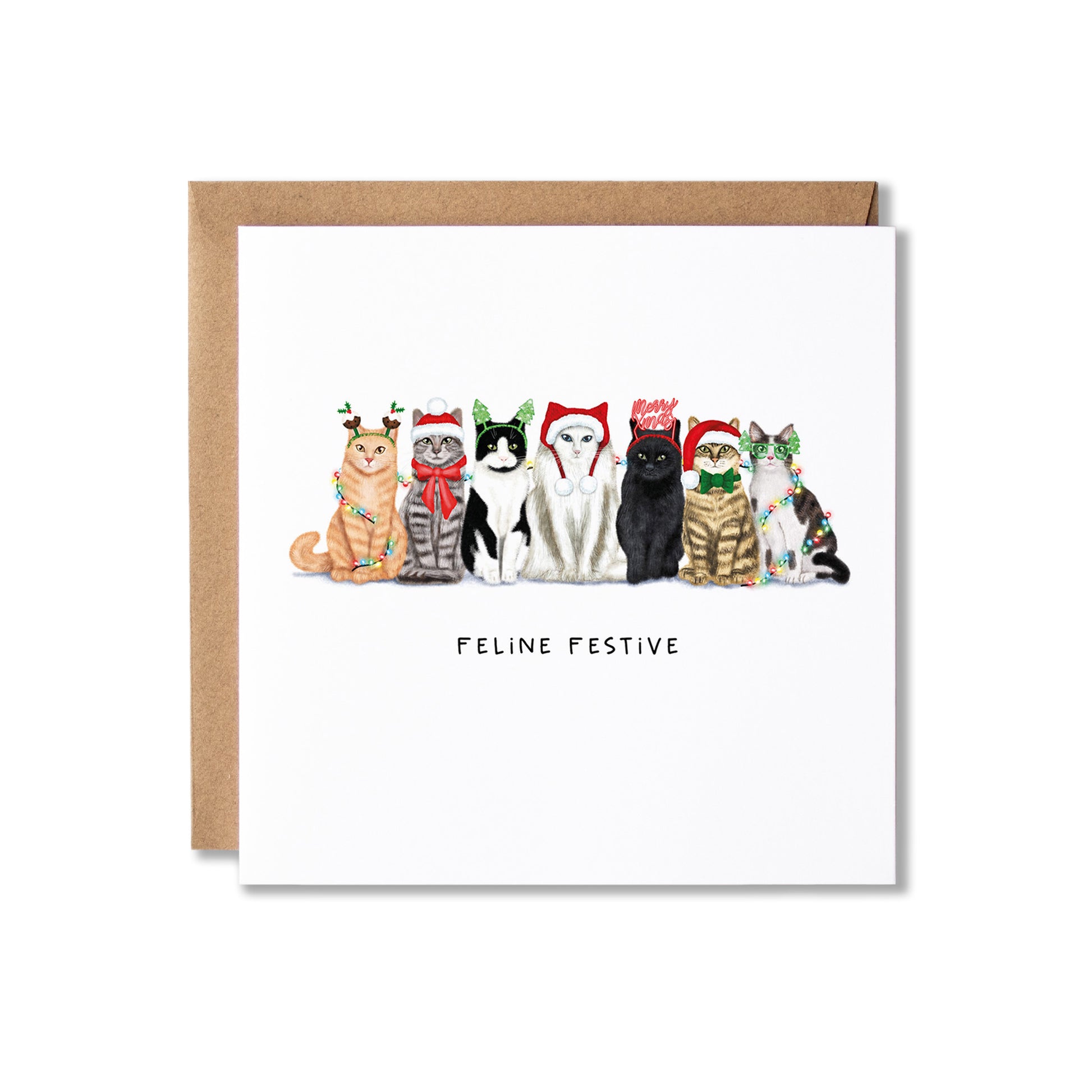 A square greeting card with a brown kraft envelope behind it, featuring an illustration of seven cats wearing Christmas hats and scarves, with the text 'FELINE FESTIVE' below them, on a white background.