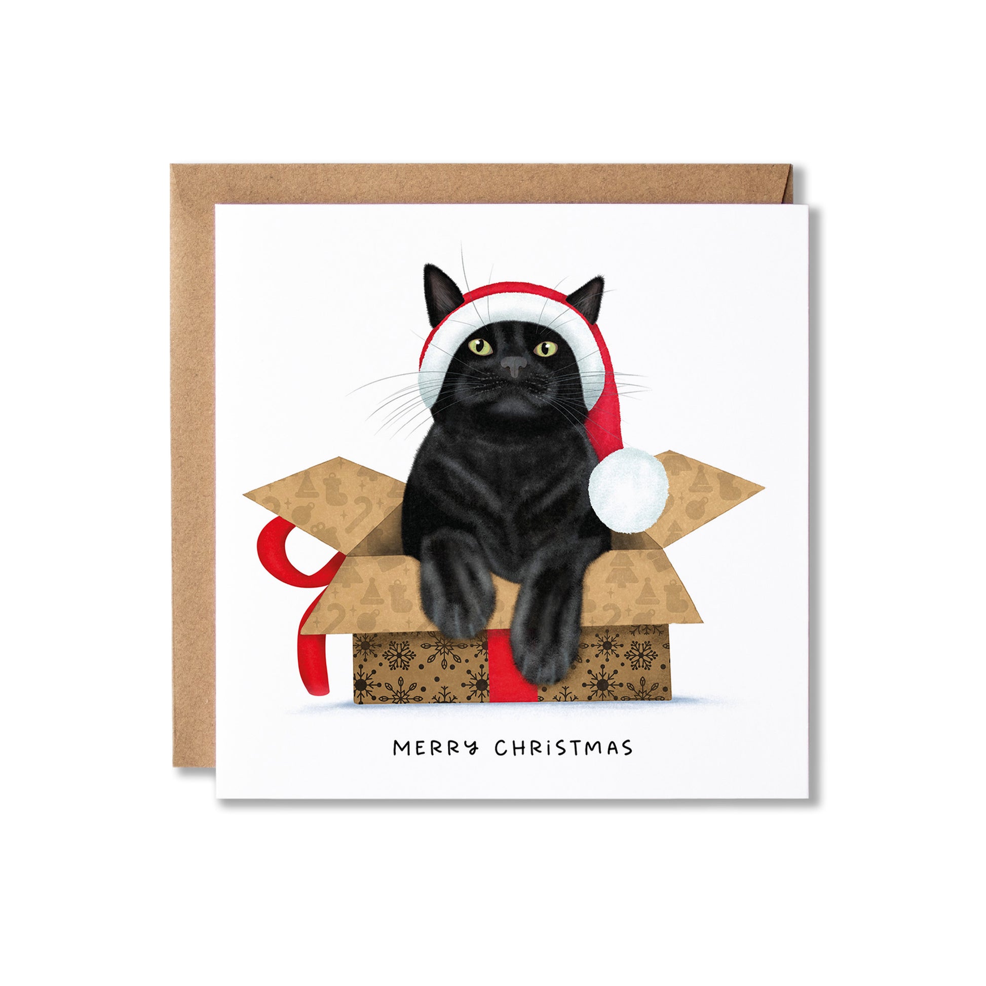 A square Christmas greeting card with a brown kraft envelope behind it. The card features an illustration of a black cat wearing a red and white Santa hat, sitting inside a gift box with a red ribbon, and the text 'MERRY CHRISTMAS' printed below.