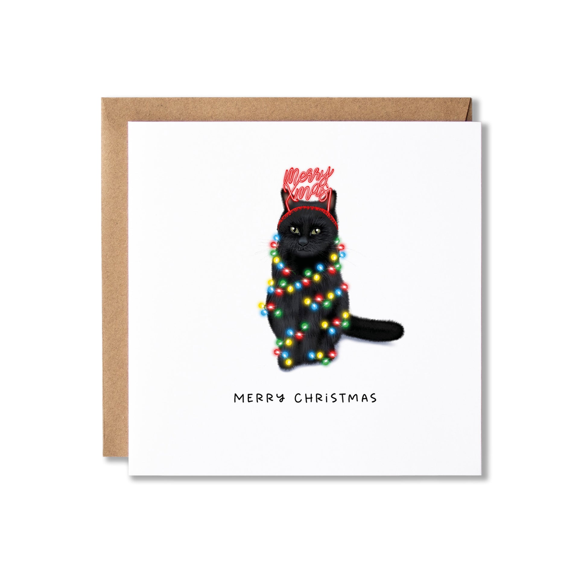 A square white Christmas greeting card with a kraft envelope behind it, featuring an illustration of a black cat wrapped in multicolored holiday lights and wearing a red 'Merry Christmas' headband, with 'MERRY CHRISTMAS' printed below.