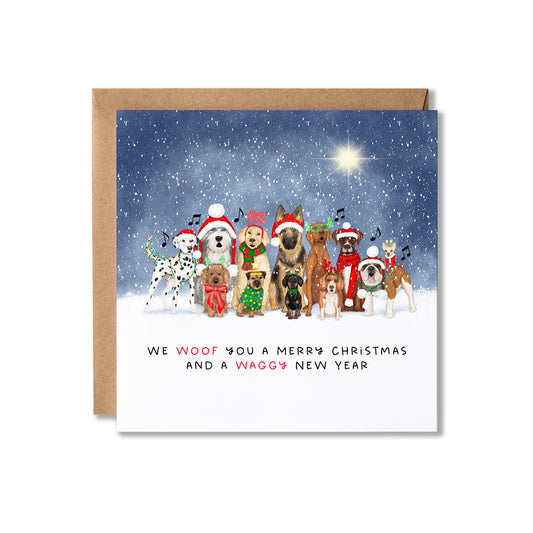A square Christmas greeting card with a kraft envelope, featuring an illustration of various dogs dressed in holiday attire under a snowy night sky. The card reads, 'WE WOOF YOU A MERRY CHRISTMAS AND A WAGGY NEW YEAR'.
