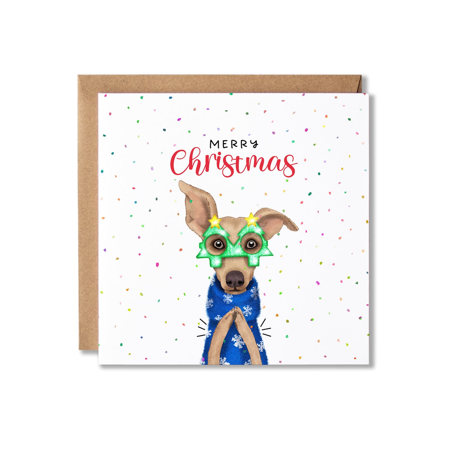 A square Christmas greeting card with a brown kraft envelope behind it. The card has a white background with scattered confetti dots and the words “Merry Christmas” above an illustrated dog wearing green holiday glasses and a blue patterned sweater.