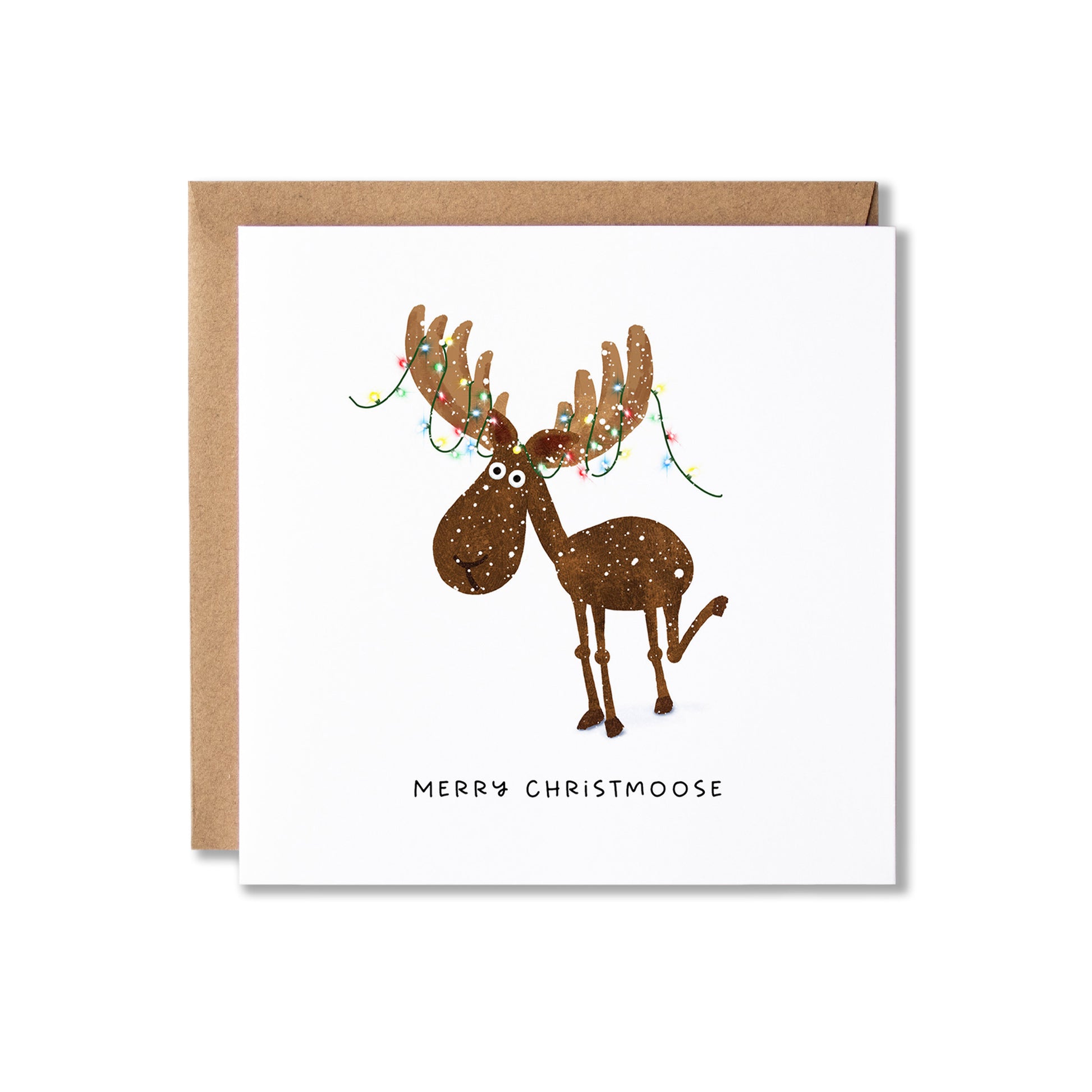A square Christmas greeting card with a brown envelope behind it, featuring a cartoon moose with antlers decorated with colorful holiday lights and the text 'MERRY CHRISTMOOSE' below.