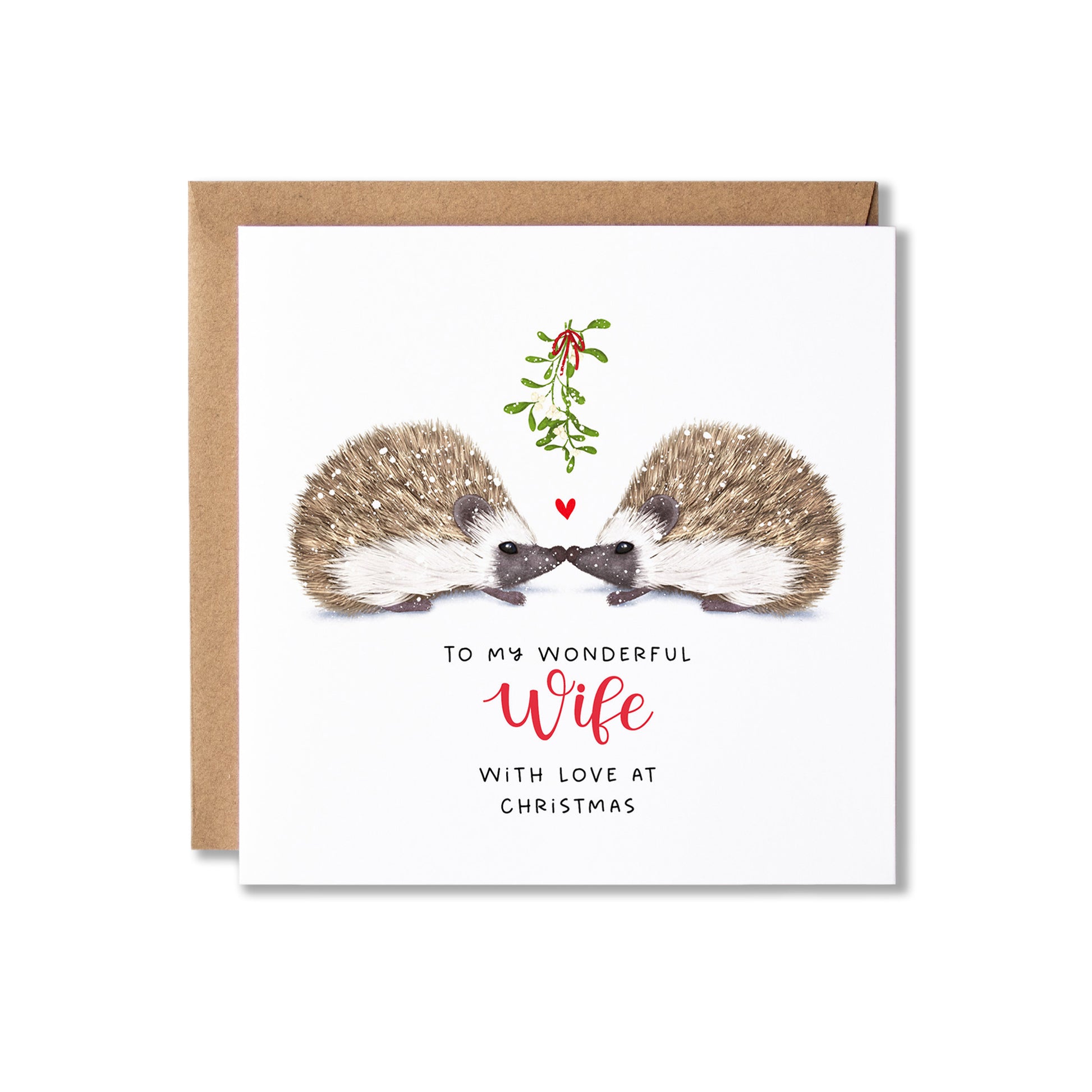 A square Christmas greeting card with a kraft envelope behind it. The card features an illustration of two hedgehogs facing each other under a small sprig of mistletoe, with the text 'TO MY WONDERFUL Wife WITH LOVE AT CHRISTMAS' below.