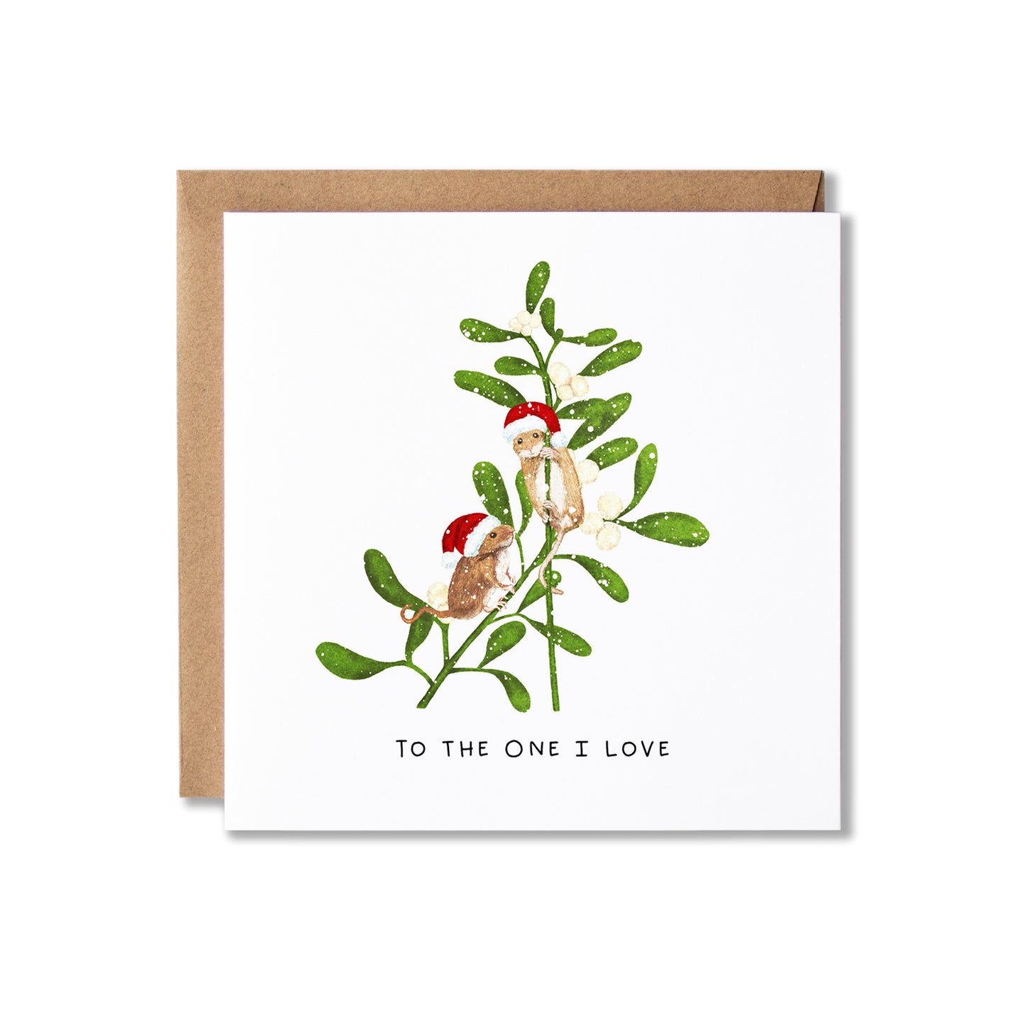 A square white greeting card with a kraft brown envelope behind it, featuring an illustration of two small mice perched on mistletoe branch with red Santa hats, and the text 'TO THE ONE I LOVE' below.