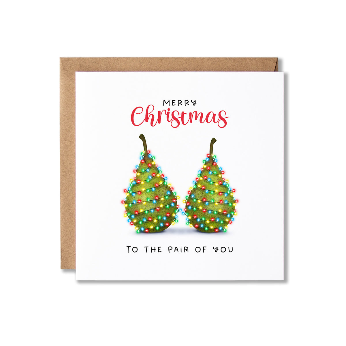 A square Christmas greeting card with a kraft envelope behind it. The card has a white background, red script text reading 'Merry Christmas', and an illustration of two green pears decorated with colourful string lights, with black text below reading 'To the pair of you'.