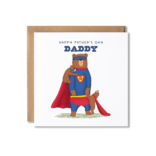 Father's Day card with illustration of a bear standing on back legs wearing a blue and red super hero costume, with a bear cub stood in front holding his hand wearing a red cape and another cub on his shoulder in a blue eye mask, with the message Happy Father's Day Daddy.
