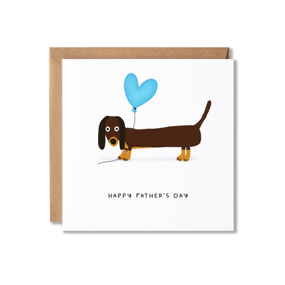 A square white Father's Day greeting card with a brown dachshund illustration holding a light blue heart-shaped balloon, shown with a kraft paper envelope behind it on a white background.
