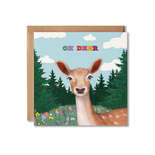 Square greeting card with an Illustration of a deer in a flower meadow with trees surrounding it. The blue sky has clouds in it with the words Oh  Deer in colourful letters. Thinking of You greeting card.