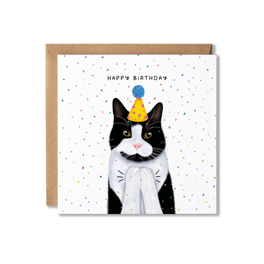 Birthday card with illustration of a black and white cat in a yellow party hat with a blue bobble on top, clapping with confetti in the background and the message Happy Birthday.