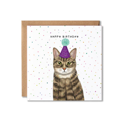 A square birthday card with a brown kraft envelope behind it. The card features an illustration of a tabby cat wearing a purple party hat with a mint green pom-pom, clapping, with the text 'HAPPY BIRTHDAY' above it.