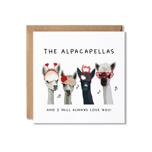 A square greeting card with a kraft envelope behind it, featuring an illustration of four alpaca heads wearing red heart-shaped glasses and accessories, with the text 'THE ALPACAPELLAS' and 'AND I WILL ALWAYS LOVE YOU!'.