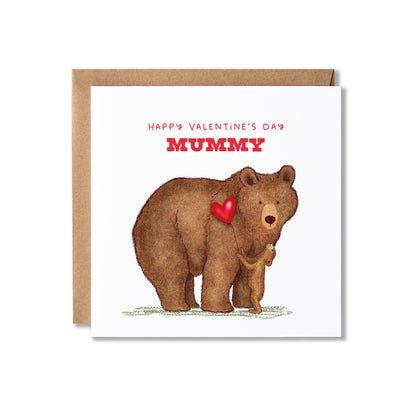 A Valentine's Day greeting card for mummies featuring an illustration of a brown bear holding a small cub and a red heart, with the text 'HAPPY VALENTINE'S DAY MUMMY' in red. The card is shown with a brown kraft envelope behind it on a white background.