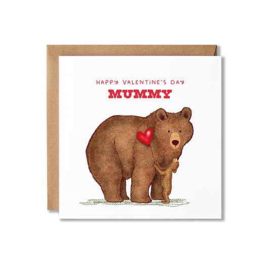 A Valentine's Day greeting card for mummies featuring an illustration of a brown bear holding a small cub and a red heart, with the text 'HAPPY VALENTINE'S DAY MUMMY' in red. The card is shown with a brown kraft envelope behind it on a white background.