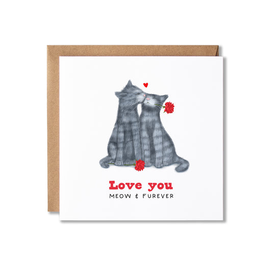 A square greeting card with a brown kraft envelope behind it, featuring an illustration of two grey cats sitting together and holding small red flowers. The text on the card reads 'Love you' and 'MEOW & FOREVER'.