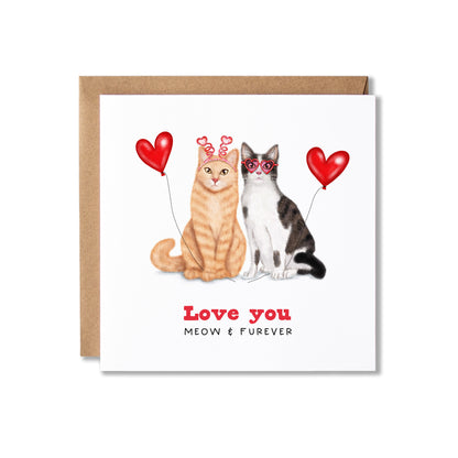 A square greeting card with a brown kraft envelope, featuring an illustration of an orange tabby cat and a black-and-white cat holding red heart-shaped balloons, with the text 'Love you' and 'MEOW & FUREVER' below.