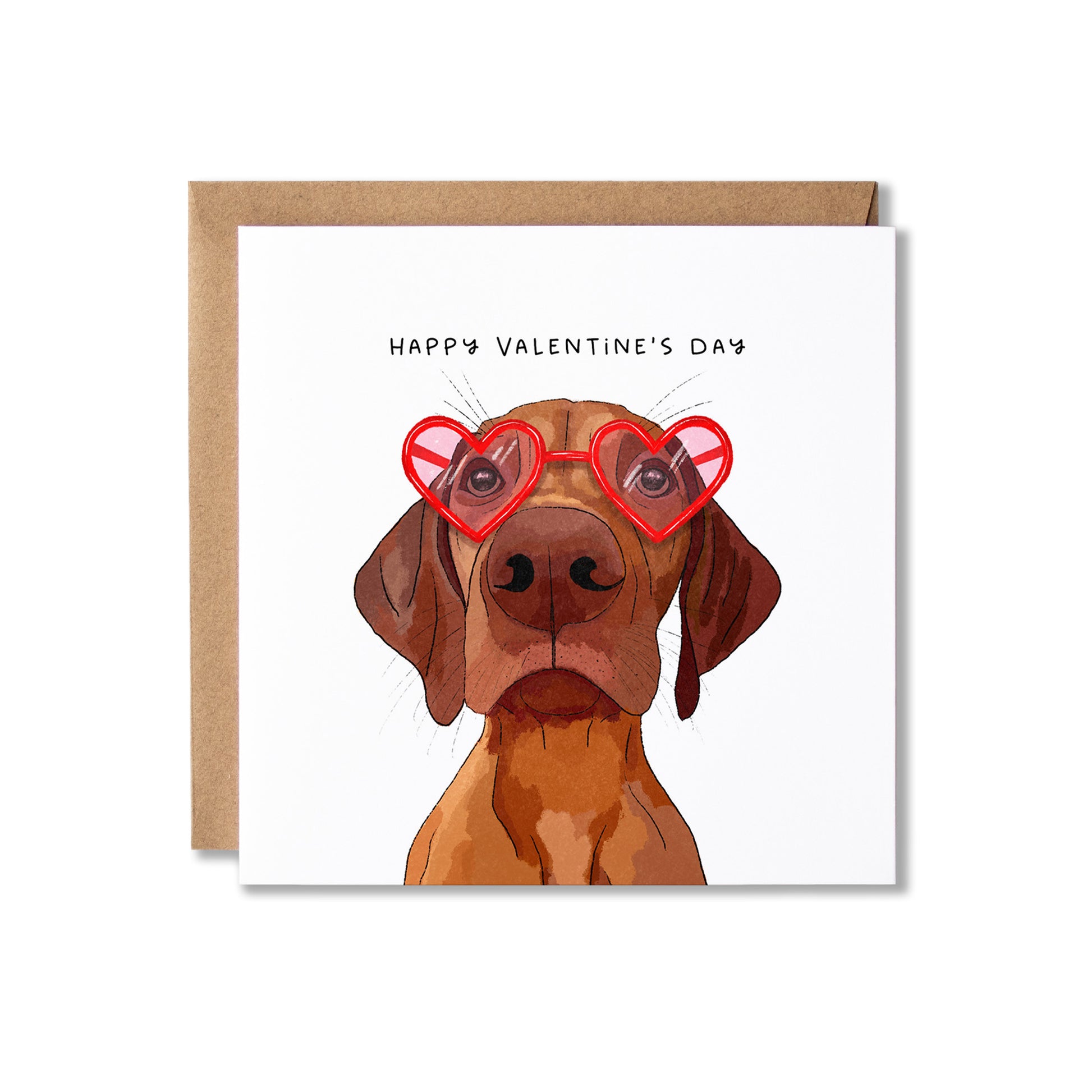 A square Valentine's Day greeting card with a Vizsla dog illustration wearing red heart-shaped glasses, and Happy Valentine's Day written above shown with a kraft envelope on a white background.
