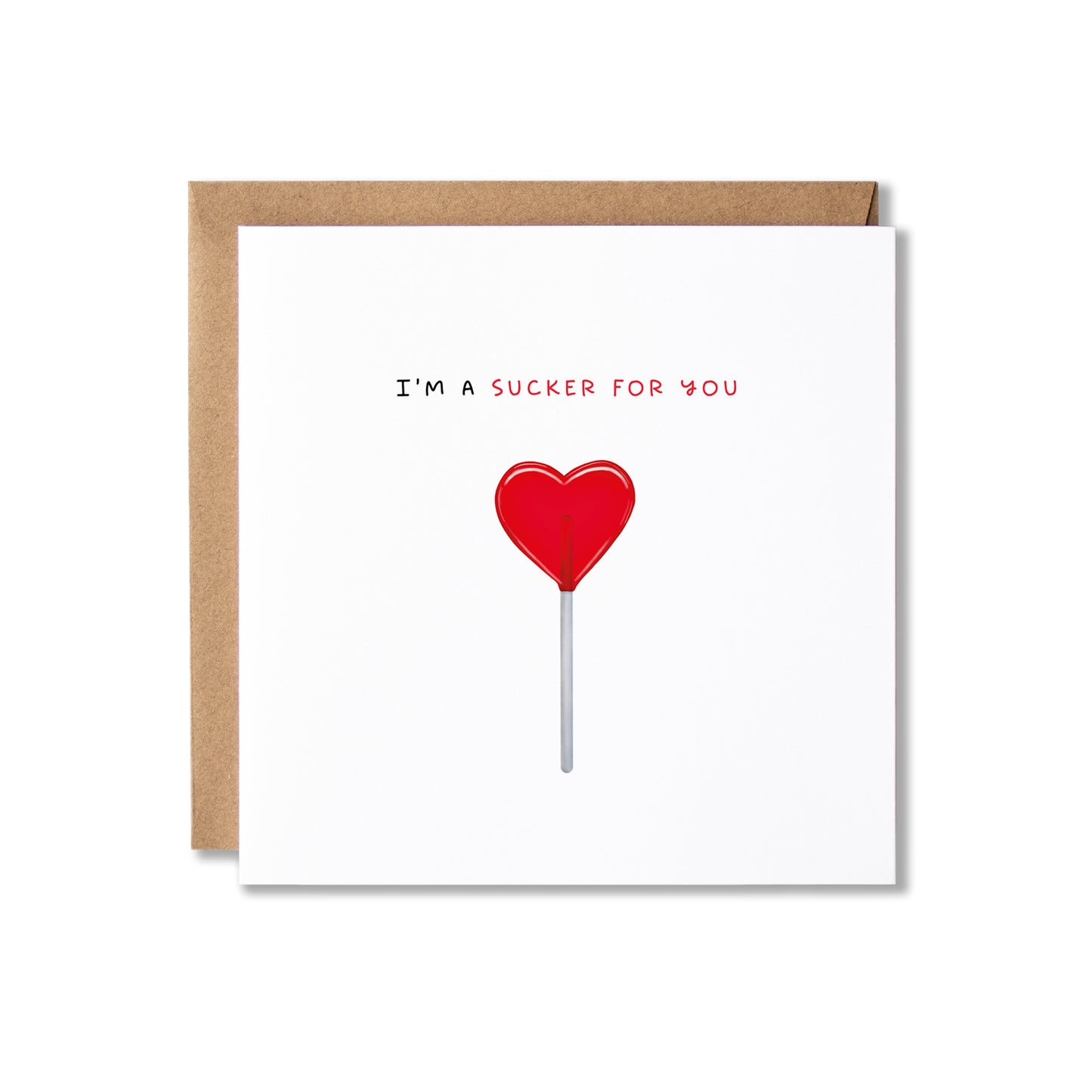 A square white greeting card with a brown kraft envelope behind it, featuring the text 'I'M A SUCKER FOR YOU' above a red heart-shaped lollipop illustration on a white background.