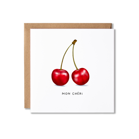 Greeting card with illustration of two red cherries and the message Mon Cherie underneath it.